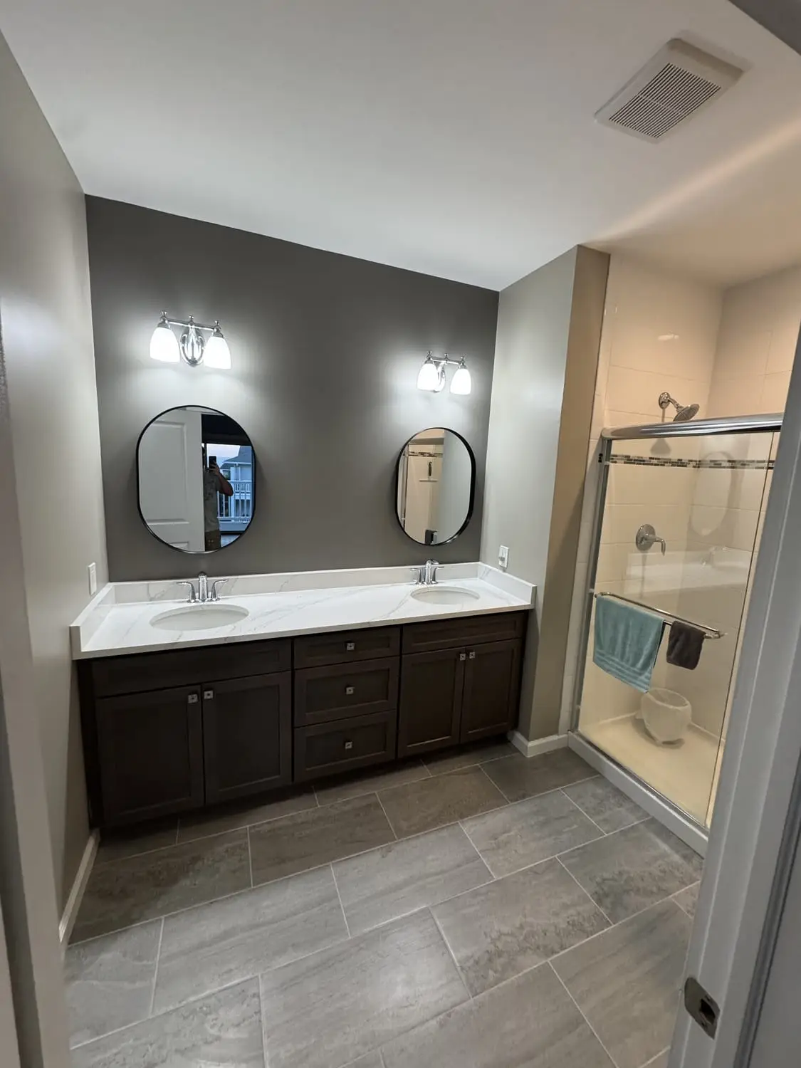 Repainted bathroom with soft grey walls, crisp white trim and a double vanity