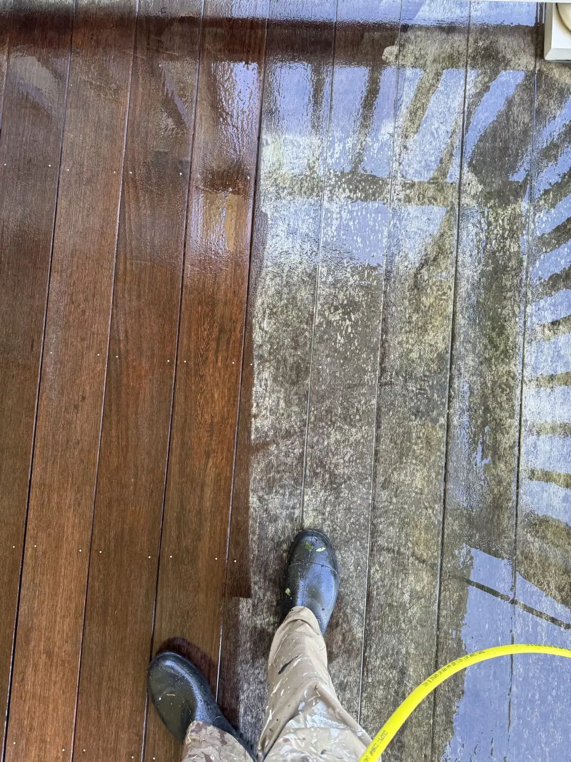 Deck being cleaned and refinished mid-project, showing the transformation