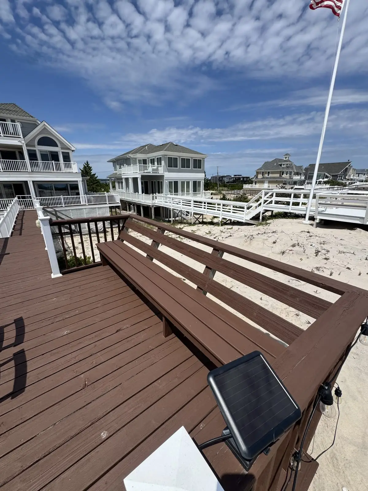 Freshly stained waterfront deck among Hamptons beach homes