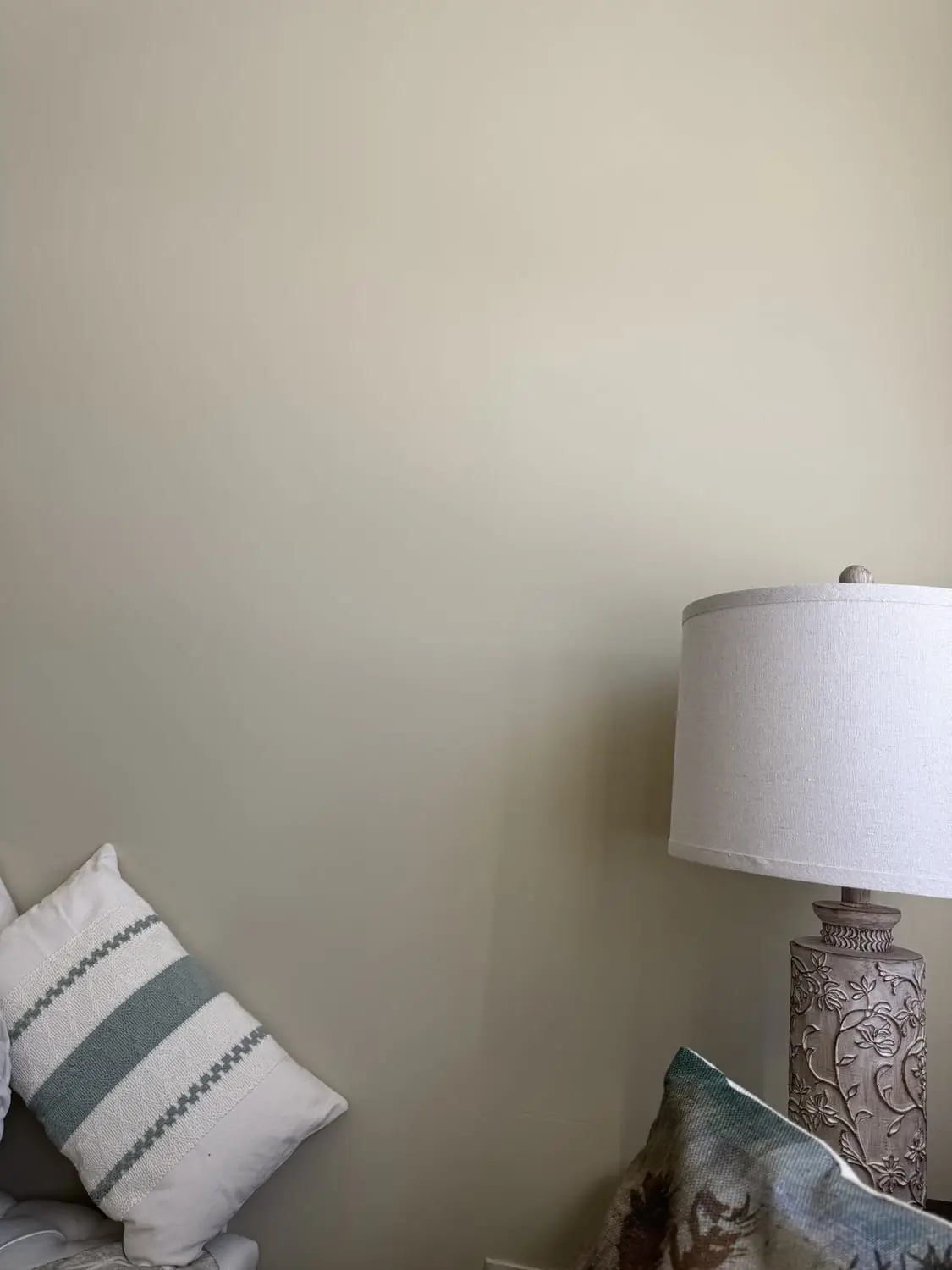 Freshly painted bedroom corner with a calm, clean neutral finish